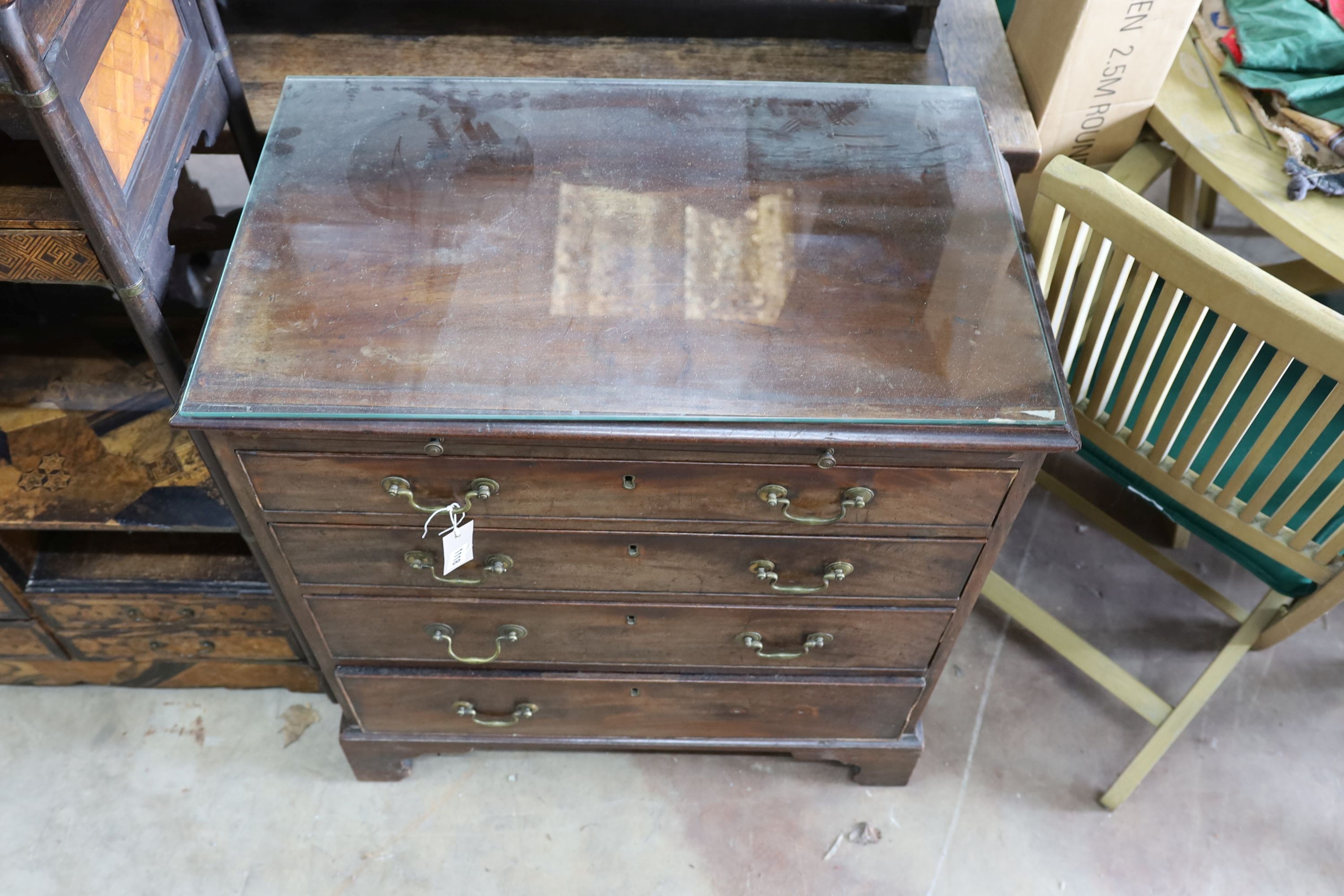 A small George III mahogany chest of three graduating long drawers and fitted slide, width 79cm, depth 47cm, height 84cm